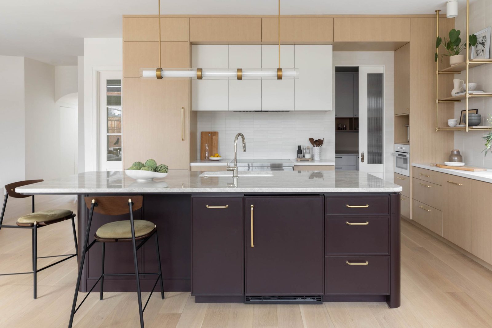 Kitchen in a Campbell new build by Memmo Interiors with white oak cabinetry, a plum island and brass hardware